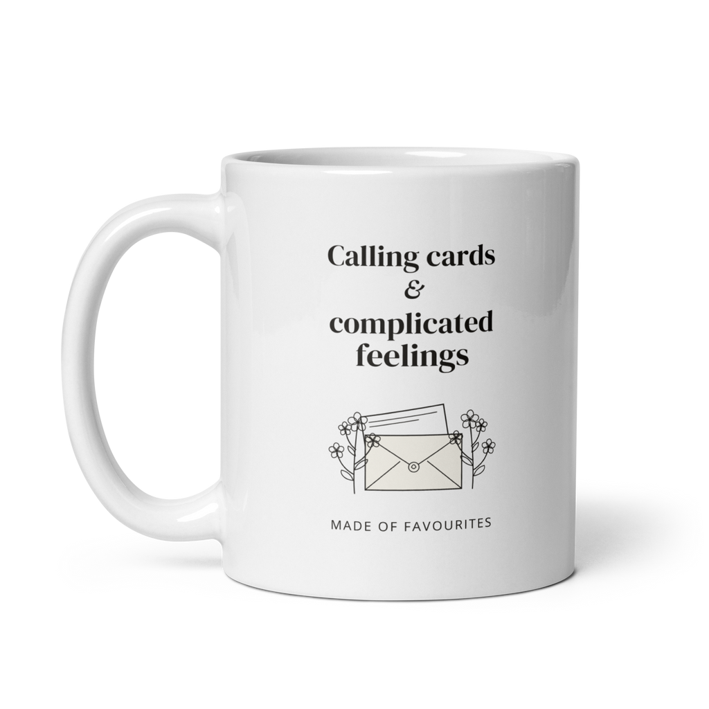 White 11 oz mug with handle on the left, showing Calling cards & complicated feelings lettering with a floral envelope. Supplier-generated mockup; not a physical sample.