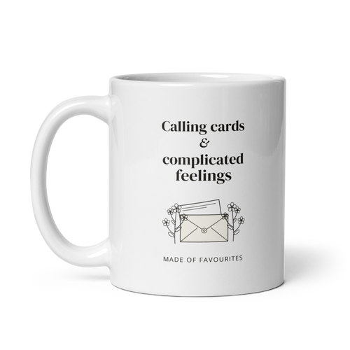 White 11 oz mug with handle on the left, showing Calling cards & complicated feelings lettering with a floral envelope. Supplier-generated mockup; not a physical sample.