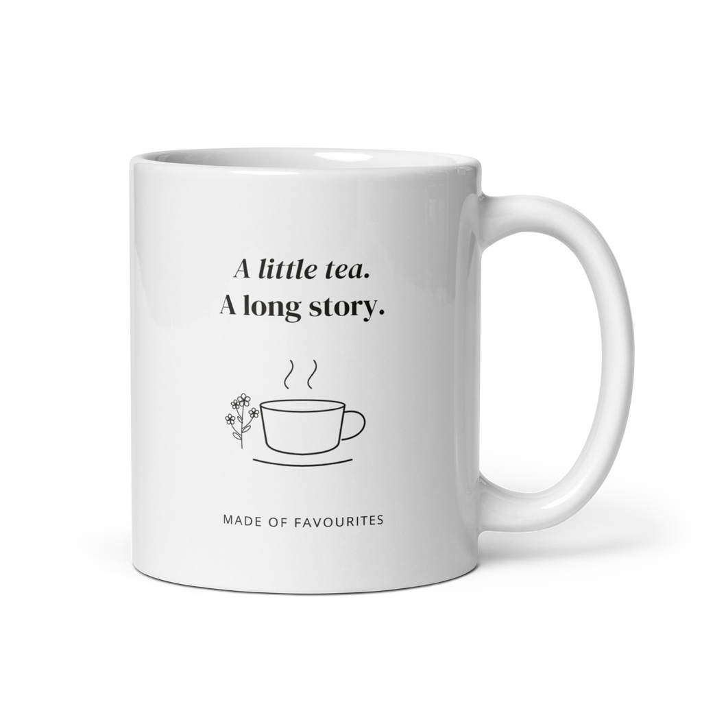 White 11 oz mug with handle on the right, showing A little tea. A long story lettering with a teacup and flowers. Supplier-generated mockup; not a physical sample.