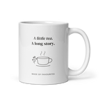 White 11 oz mug with handle on the right, showing A little tea. A long story lettering with a teacup and flowers. Supplier-generated mockup; not a physical sample.