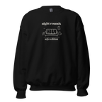 Front of black Night Rounds, Sofa Edition crewneck with cream lettering and a sofa, remote, mug and fictional chart. Supplier-generated mockup; not a physical sample.